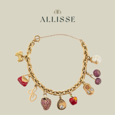 A gold charm bracelet by Catanachs